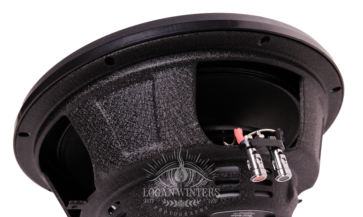 Close-up of the back side of an American Bass SL 12″ Car Subwoofer (300 Watts RMS, Single Voice Coil 4 Ohm, Shallow Mount), highlighting the textured frame, wiring connectors, and metal terminals—designed in a space-saving shallow mount style—with a watermark reading Logan Winters Photography across the bottom.