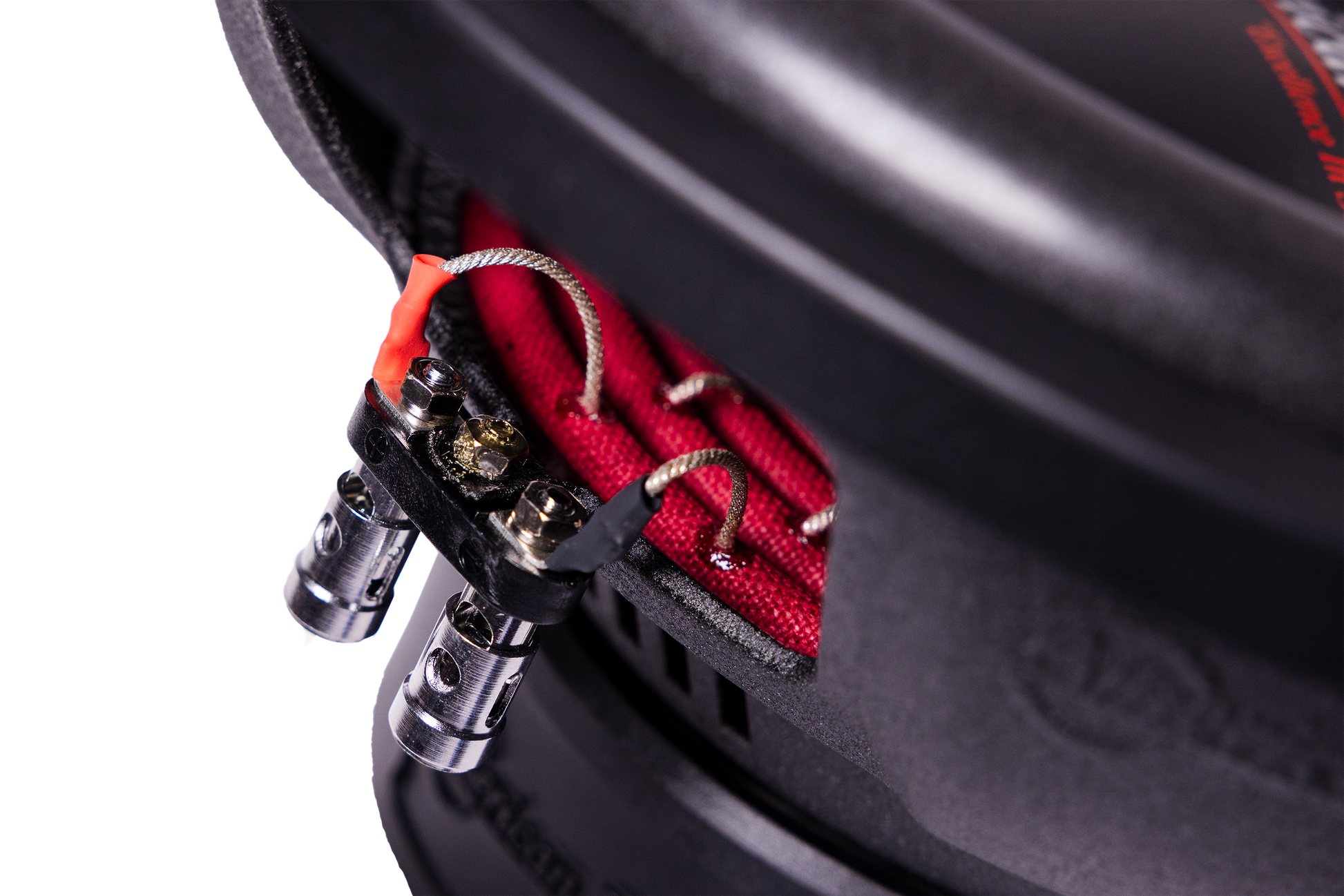 Close-up of the wiring terminals on the American Bass Audio Ground Pound Bundle—featuring silver wires connected to metal connectors and red fabric material inside the enclosure—perfectly suited for setups with a VFL Rebel REBEL-3000.1 amplifier and dual DX 12" subwoofers.