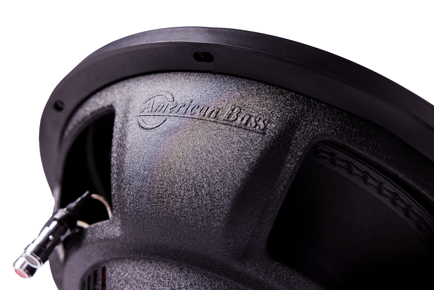 Close-up of an American Bass Audio DX 12" subwoofer from the Ground Pound Bundle, featuring the brand name embossed on its textured surface, visible wiring, and intricate speaker detailing—an ideal match for a setup with dual 12" subwoofers and the VFL Rebel REBEL-3000.1 monoblock amplifier.