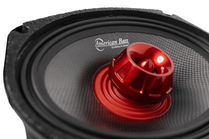 Close-up of the American Bass Audio Biker Series 6x9 Midrange Speaker showing the red dome, carbon fiber cone, and American Bass 'Excellence in Sound' logo.